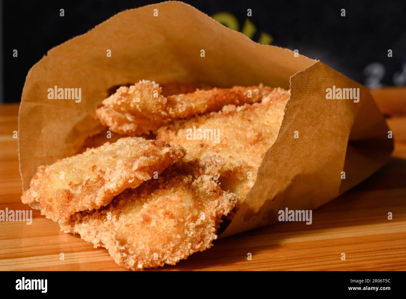 Chicken nuggets in a paper bag on the table, cooked fried chicken ...