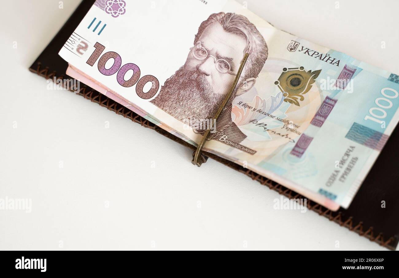 Ukrainian hryvnia money in leather money clip, wallet. Ukraine money on white background with. Currency of Ukraine. Accessories. Money, financess Stock Photo