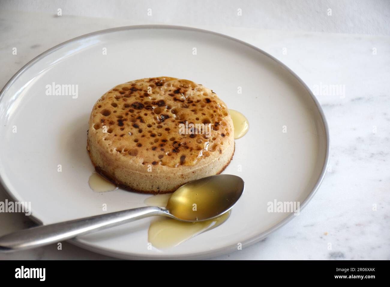 crumpet for breakfast with honey topping Stock Photo
