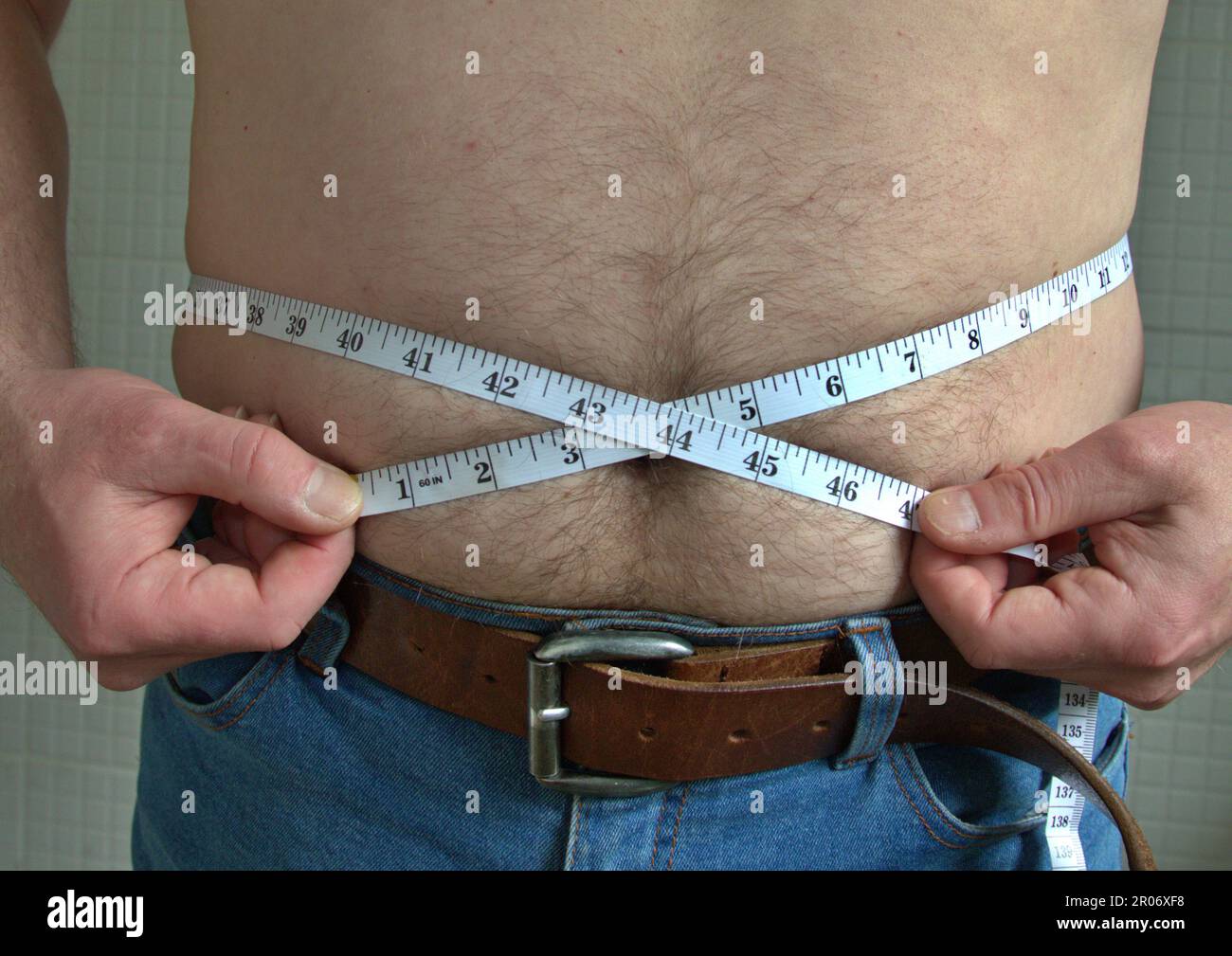 Normal sized male waistline being measured Stock Photo