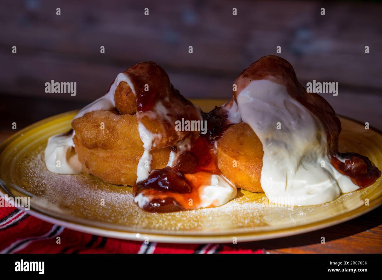 Papanasi - a traditional Romanian dessert. The cake is made from three ...