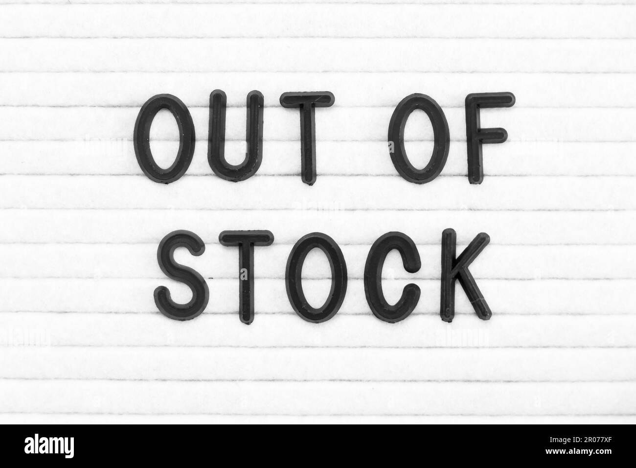 Black color letter in word out of stock on white felt board background Stock Photo Alamy