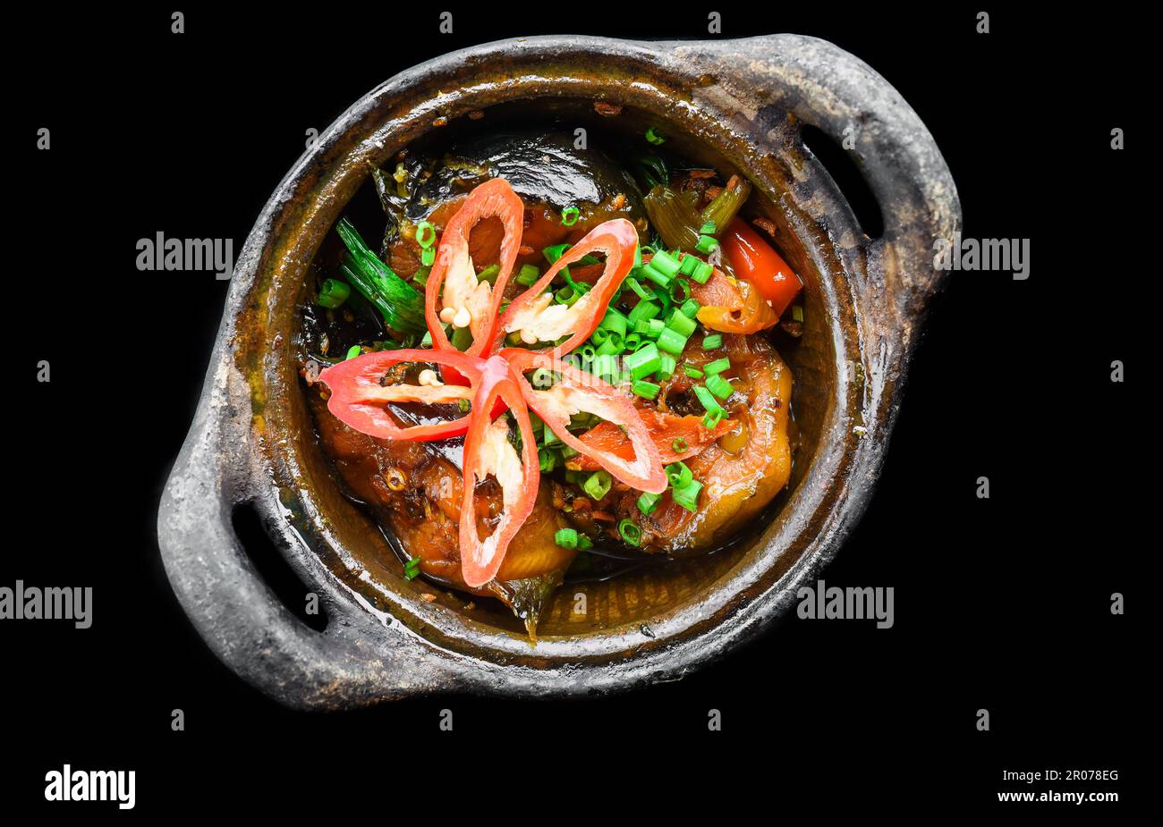 Vietnamese fried Mackerel fish with sauce on black background Stock