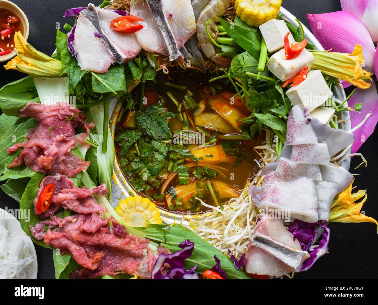 Vietnamese hot pot with raw seafood on black background Stock Photo Alamy