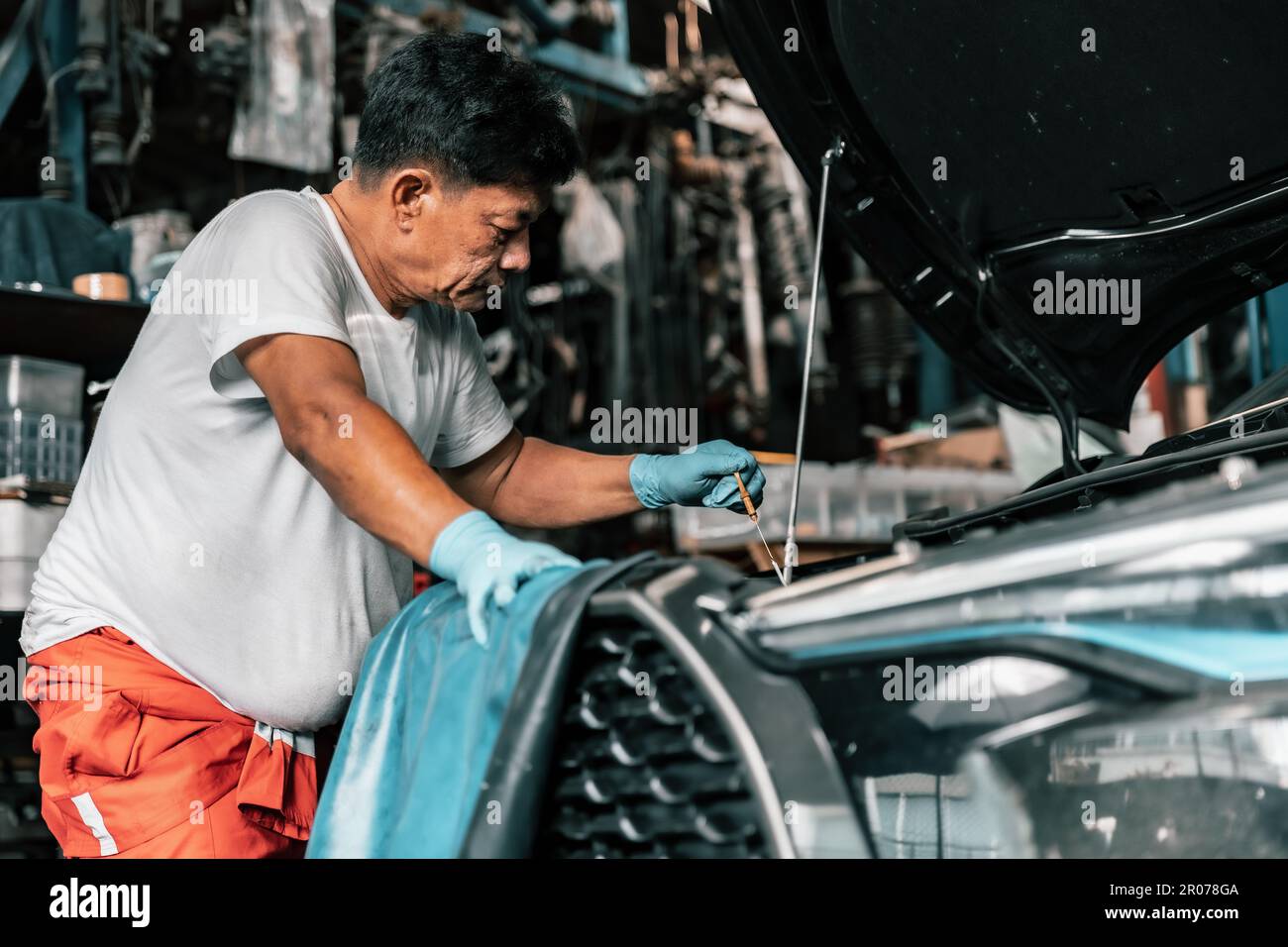 Auto mechanic diagnose and troubleshoots with tools and equipment