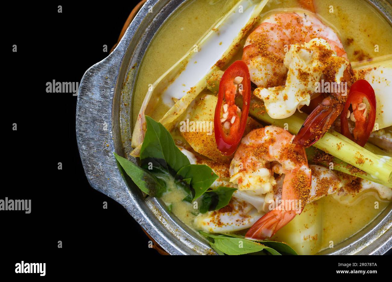 Vietnamese curry with shrimps and potato on black background for a menu Stock Photo