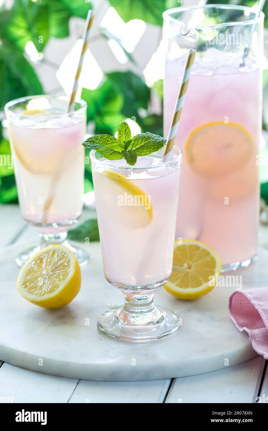 Refreshing lemonade with pink lemonade ice cubes, ready for drinking. Stock Photo