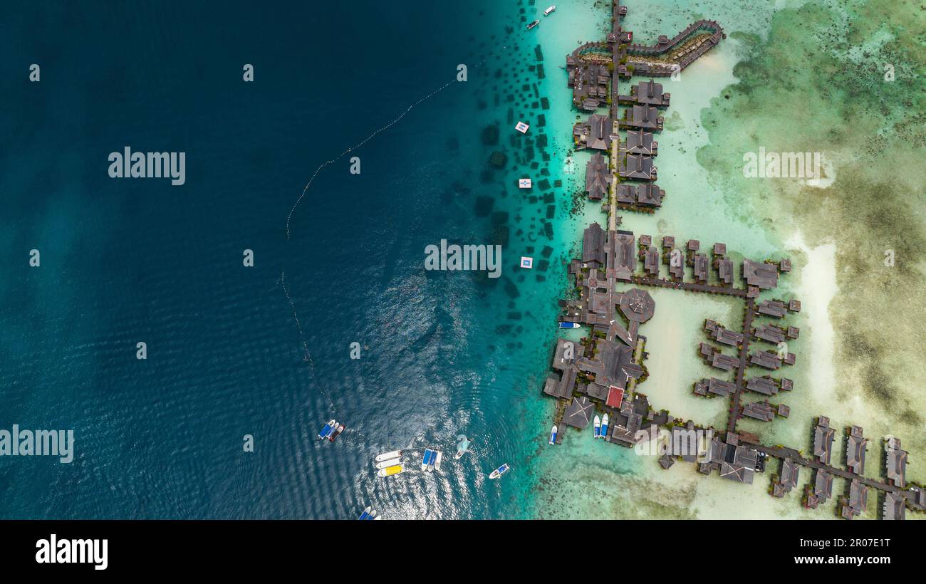 Island Mabul in the blue sea with a coral reef and the beach view from above. Semporna, Sabah, Malaysia. Stock Photo
