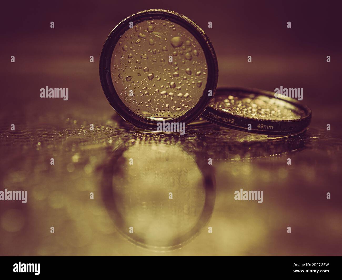 lens filters with water droplets reflected in the mirror Stock Photo