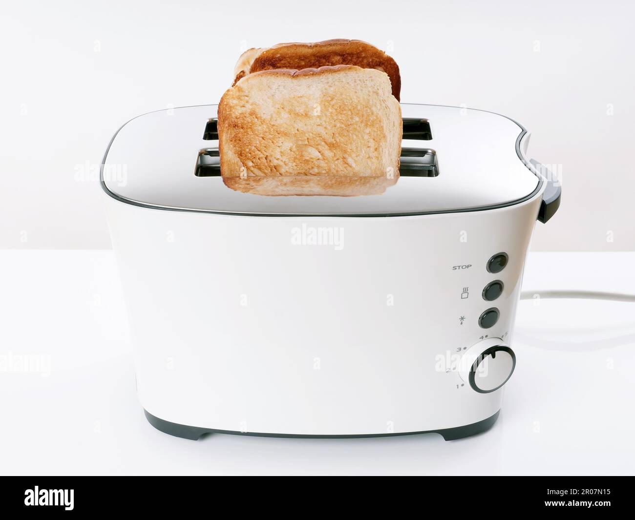 Toasting sliced bread in toaster stock photo alamy