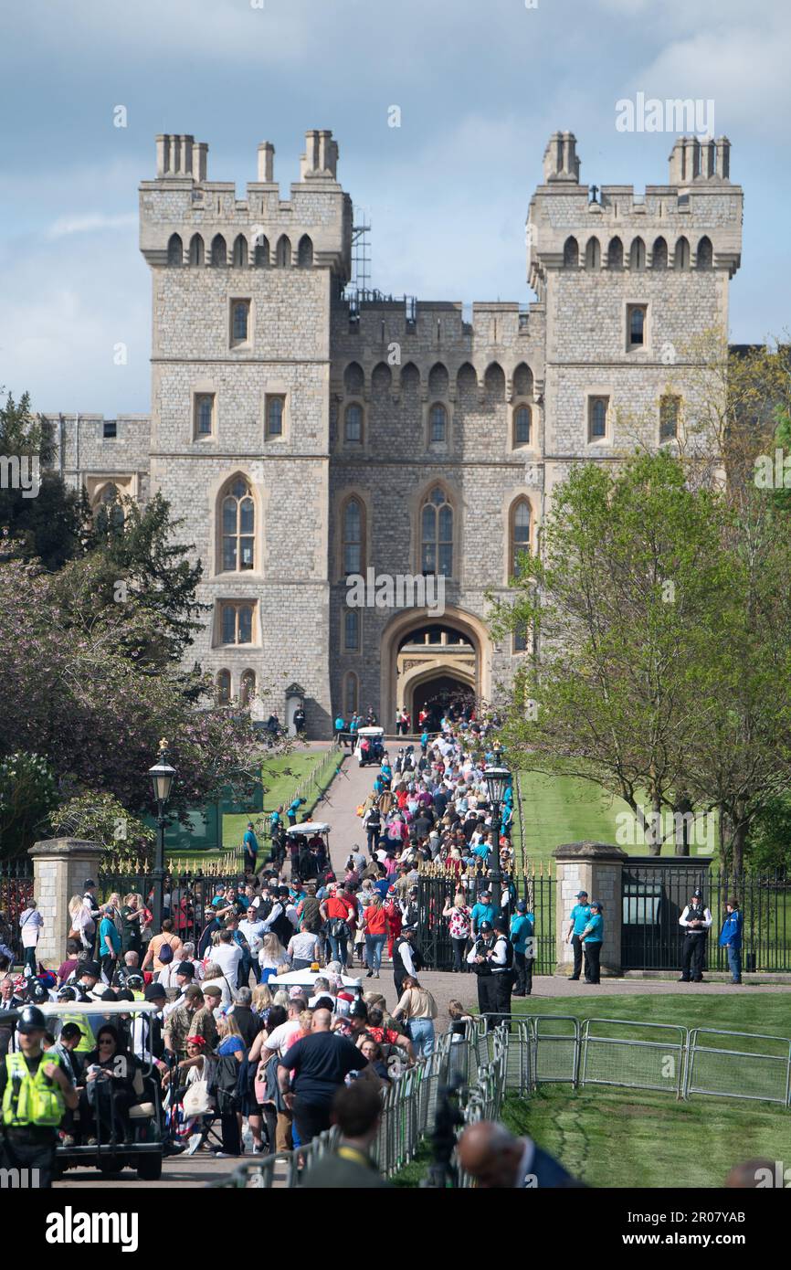 Windsor, Berkshire, UK. 7th May, 2023. The Coronation Concert guests queuing on the Long Walk in Windsor and heading through the Cambridge Gate into the private grounds of Windsor Castle. 20,000 lucky ticket holders will enjoy the Coronation Concert this evening in the presence of the Royal Family. Credit: Maureen McLean/Alamy Live News Stock Photo