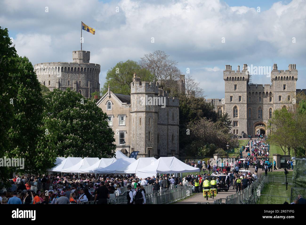 Windsor, Berkshire, UK. 7th May, 2023. The Coronation Concert guests queuing on the Long Walk in Windsor and heading through the Cambridge Gate into the private grounds of Windsor Castle. 20,000 lucky ticket holders will enjoy the Coronation Concert this evening in the presence of the Royal Family. Credit: Maureen McLean/Alamy Live News Stock Photo