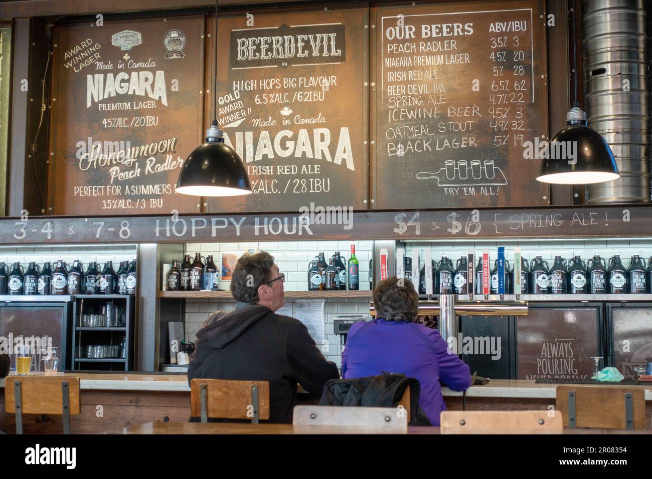 Customers Looking At The Menu Board Inside Niagara Brewing Company Pub Niagara Falls, Ontario, Canada. Canadian Micro Brewery Brew Pub. Stock Photo