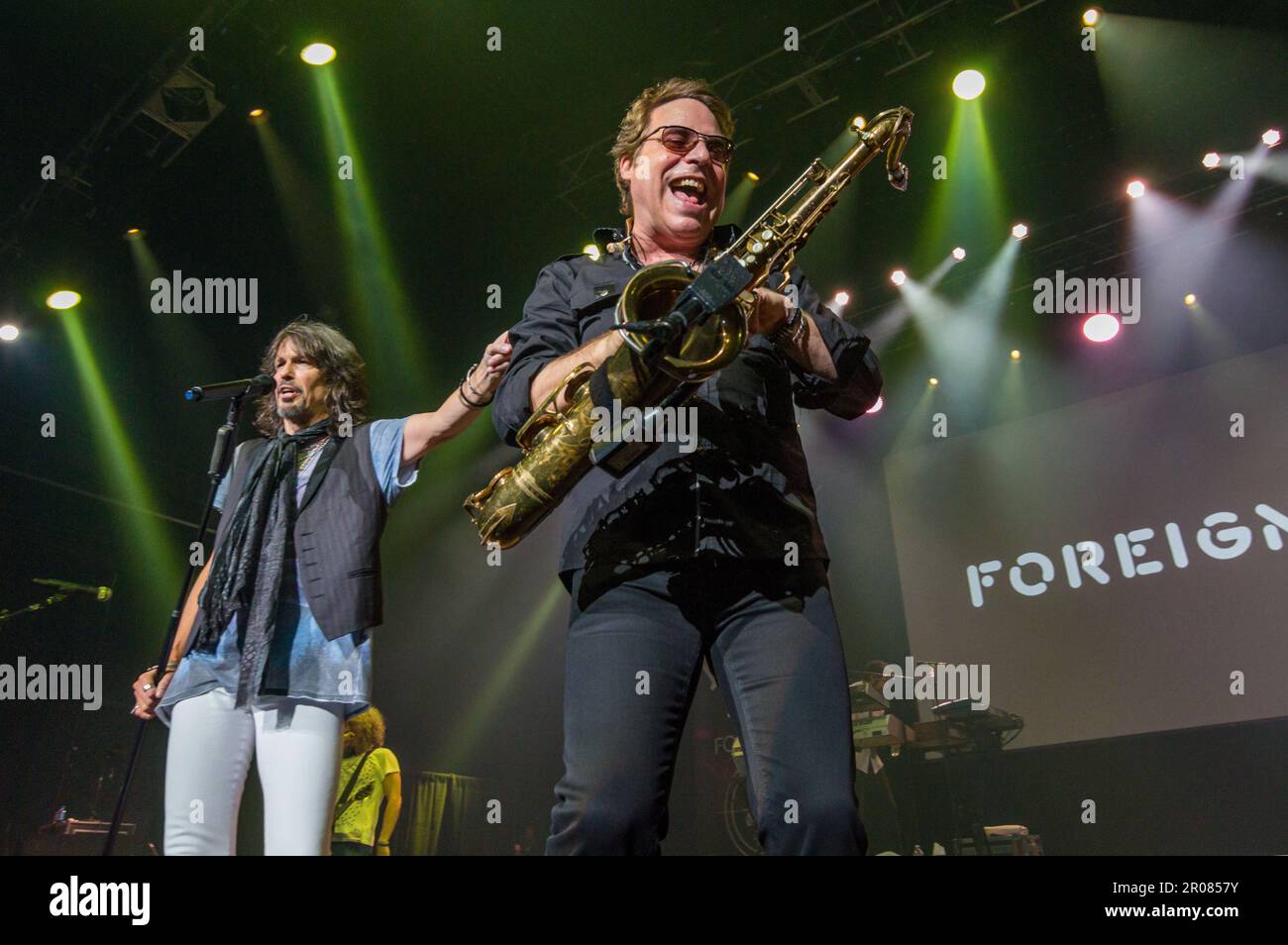 12 April, 2015, Las Vegas, Nevada: Foreigner vocalist Kelly Hansen introduces sax player Thom Gimbel during a corporate show. Stock Photo