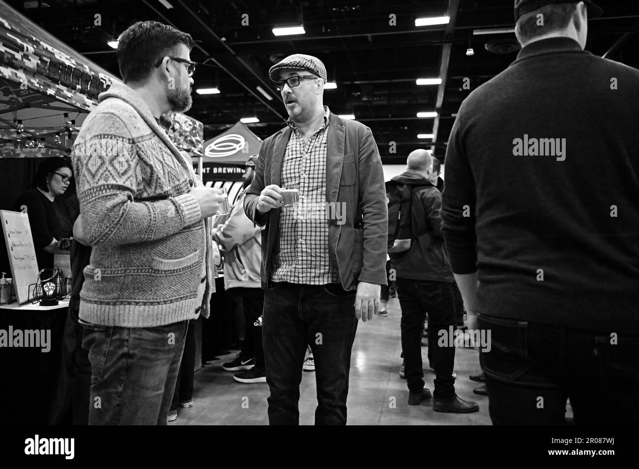 CALGARY BEER FESTIVAL two white men in glasses talk while sampling