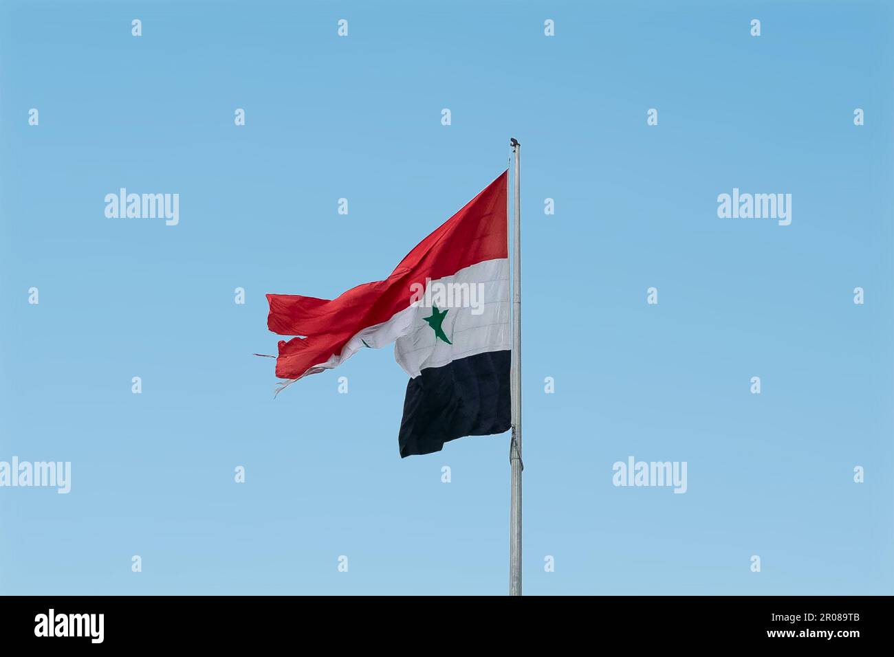Damascus, Syria - May, 2023: Old tattered national flag of Syria, Syrian Arab Republic Stock Photo