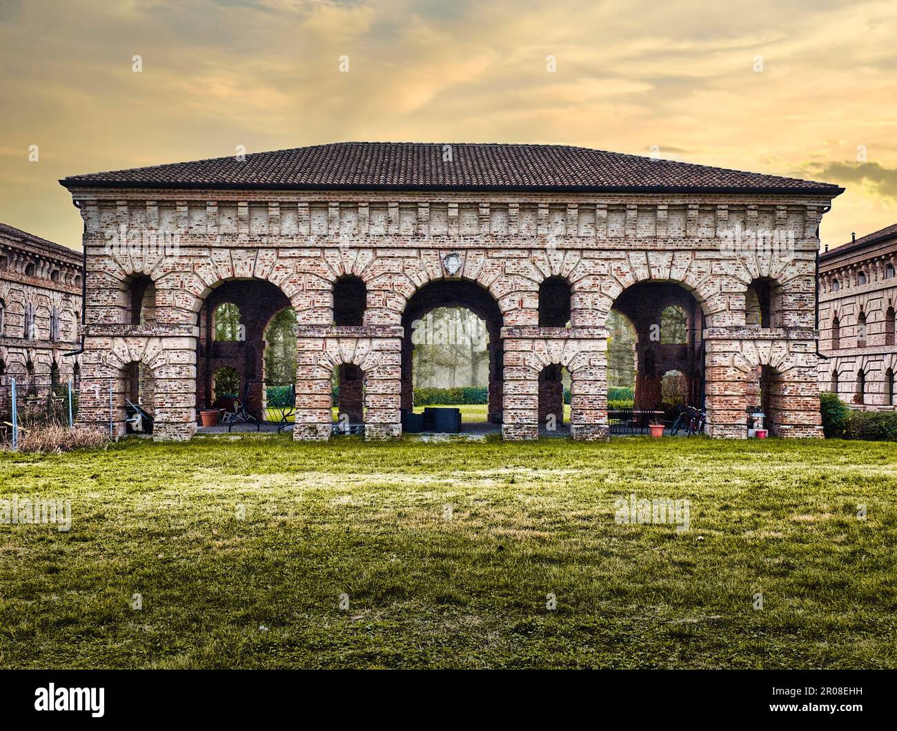 Corte Spinosa (16th century) in Porto Mantovano near Mantua (Lombardy, Italy) at sunset. One of the ancient buildings used to store crops or tools. Stock Photo