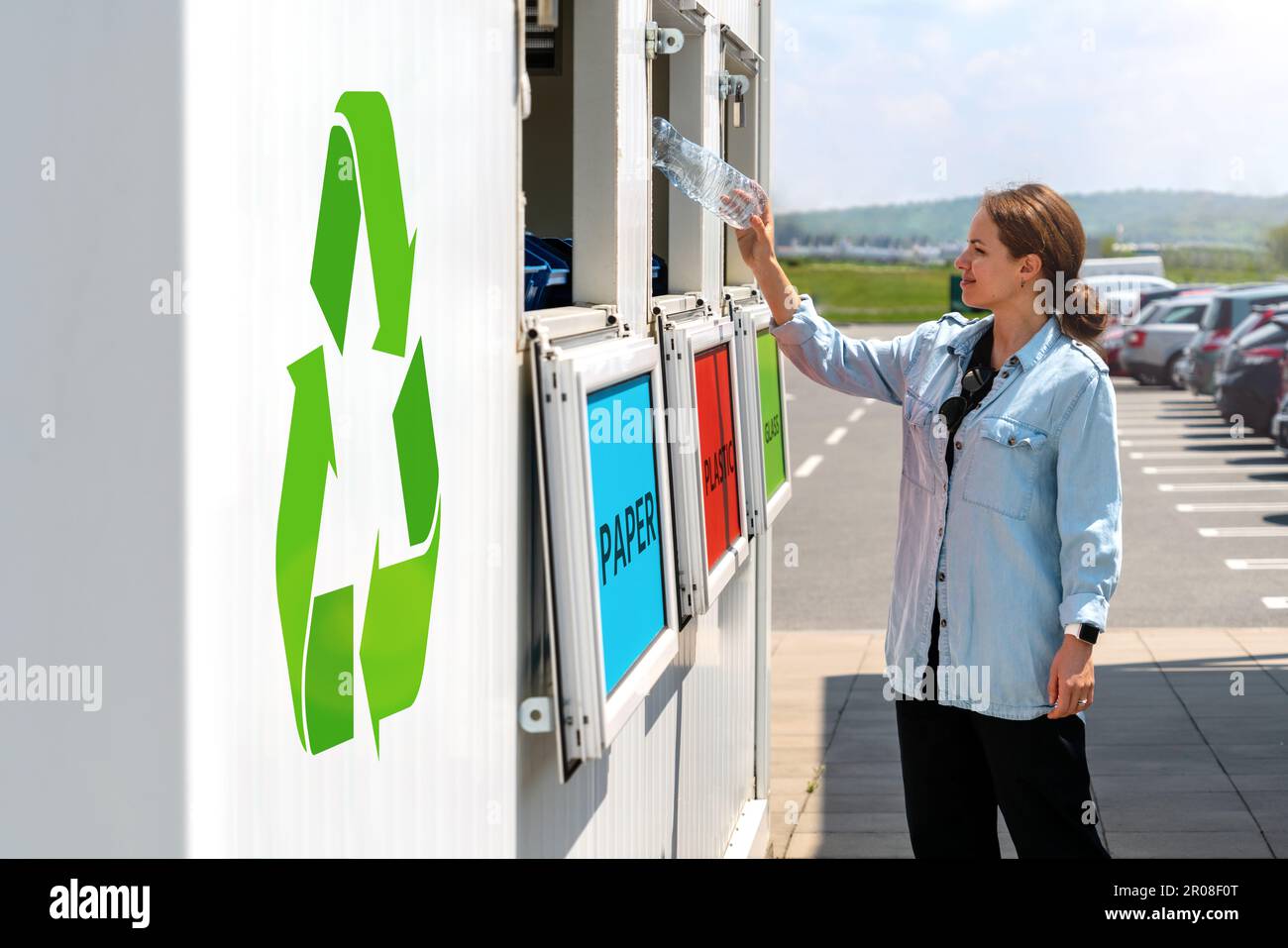 Woman throwing plastic bottle in waste bin. Recycle concept, green
