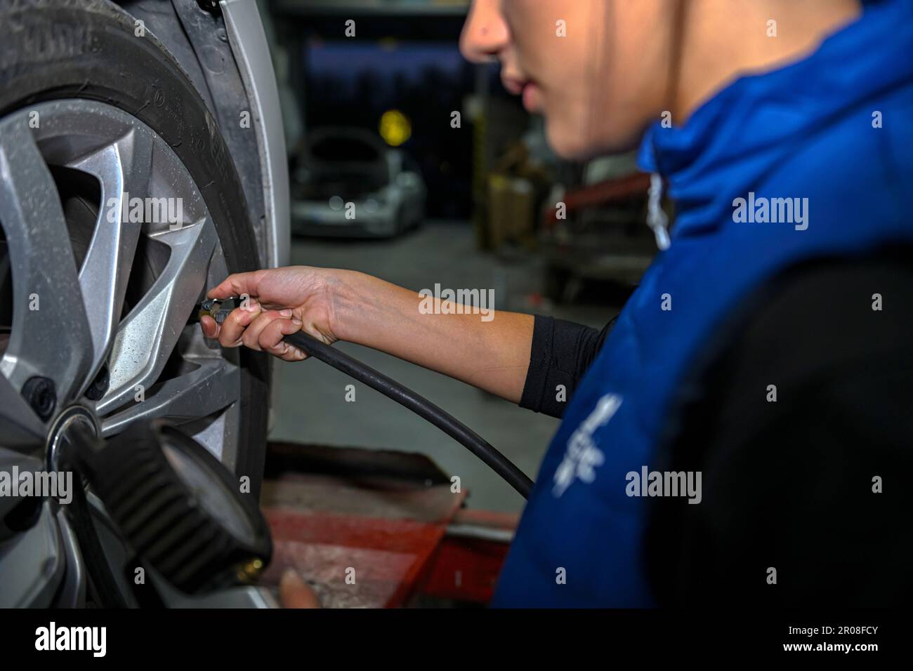 Young female mechanic, working on the repair of a car engine Stock ...