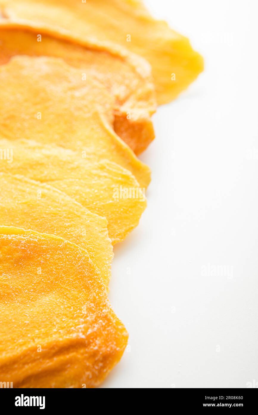 Dried large sweet mango slices on white background.Macro Stock Photo