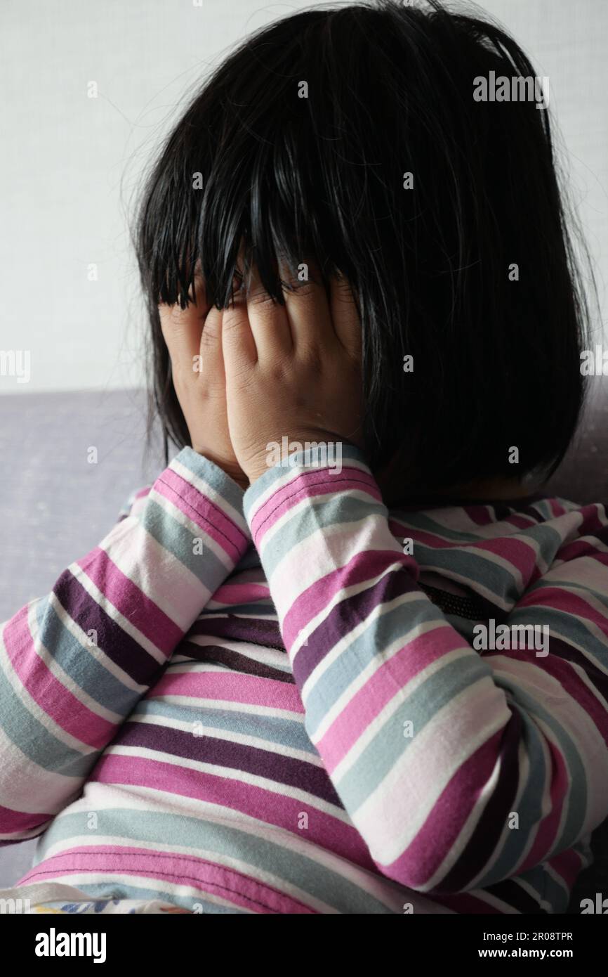Upset child girl cover face hi-res stock photography and images - Alamy
