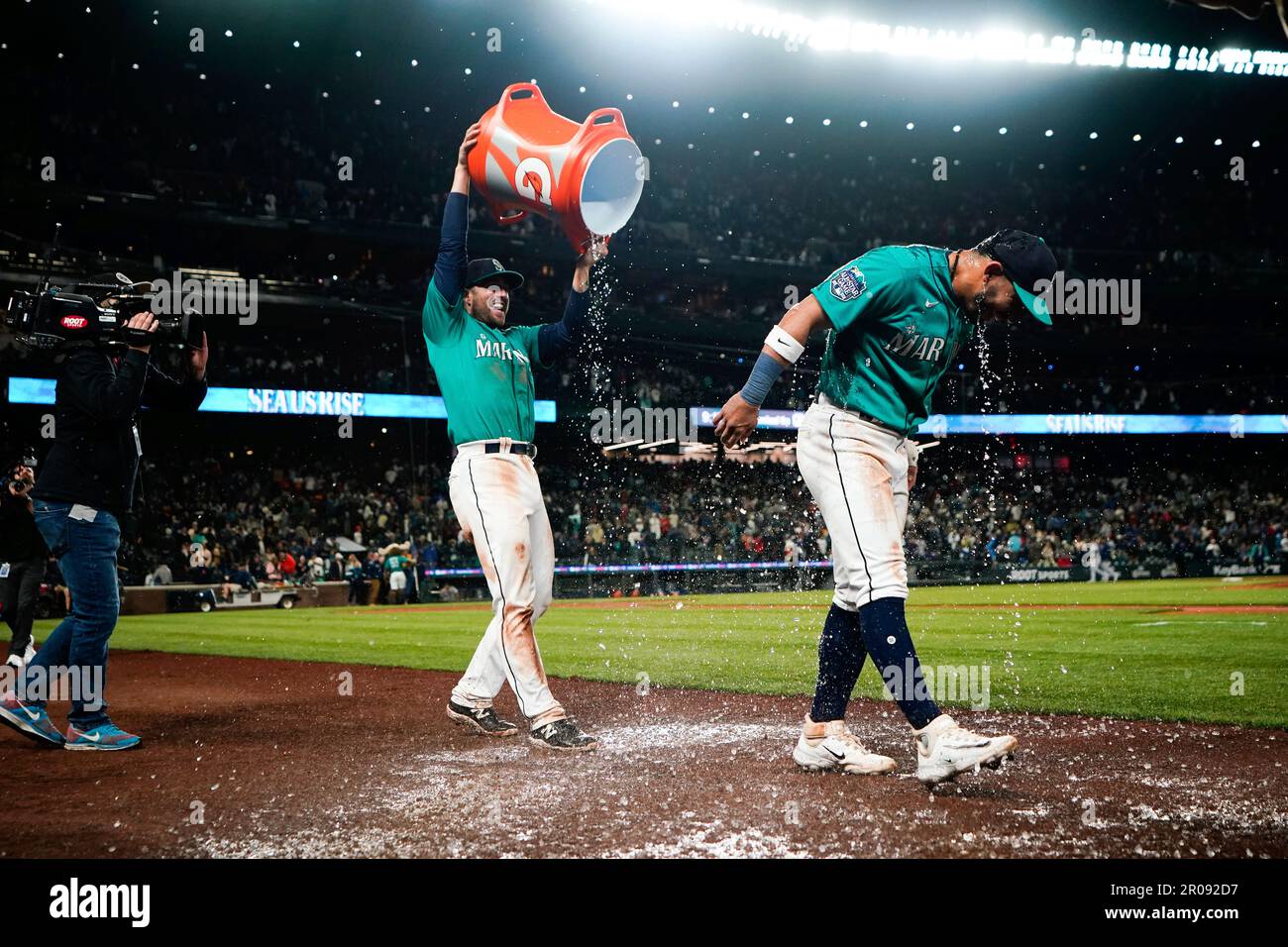 Seattle Mariners catcher Tom Murphy, left, smiles after dousing second