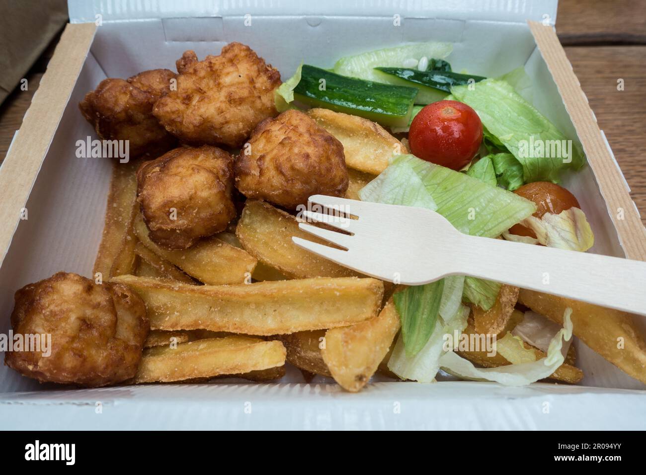 Children chicken nuggets meals in a box with wooden fork Stock Photo