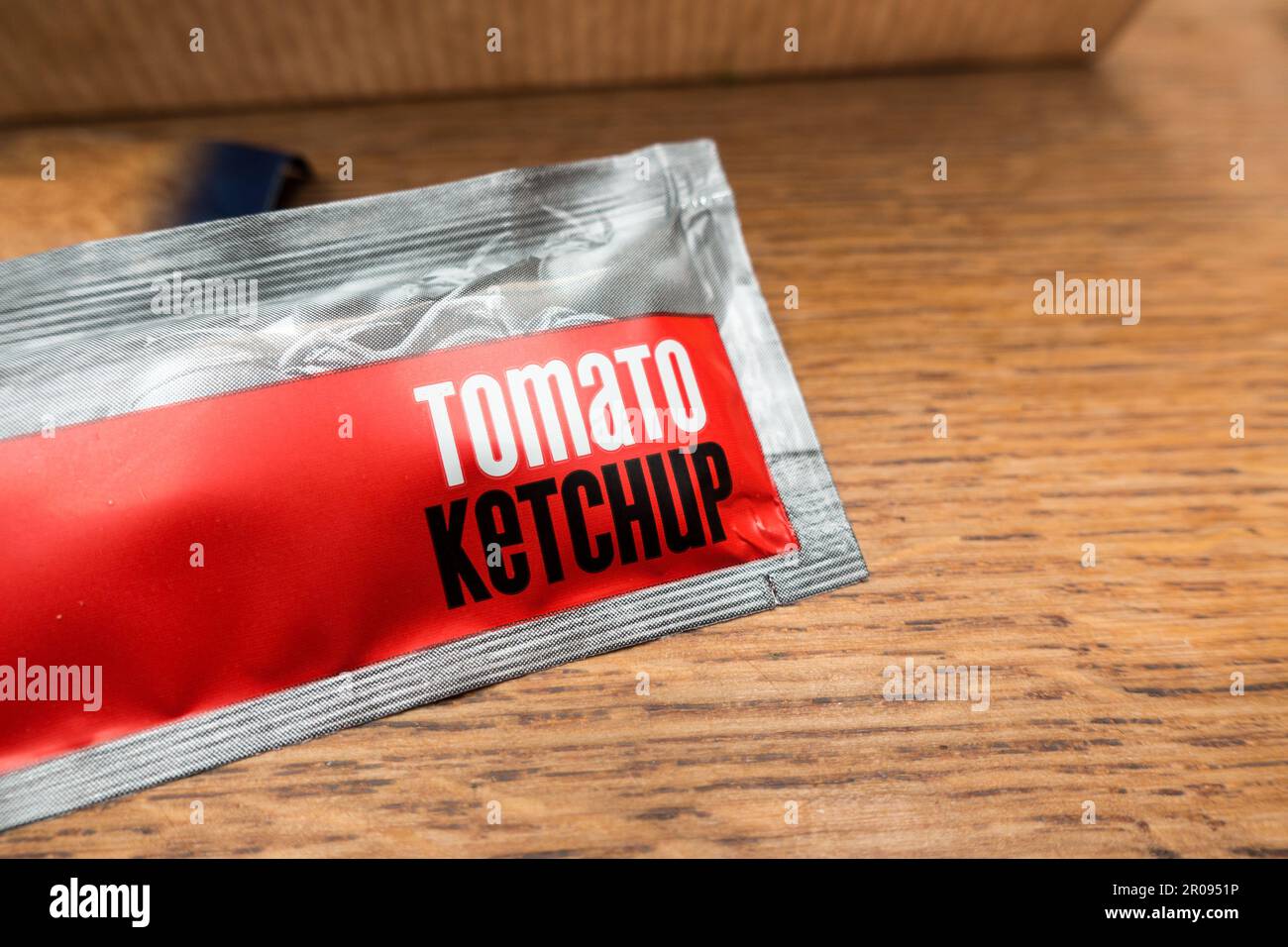 Tomato Ketchup sauce sachet isolated on a table Stock Photo