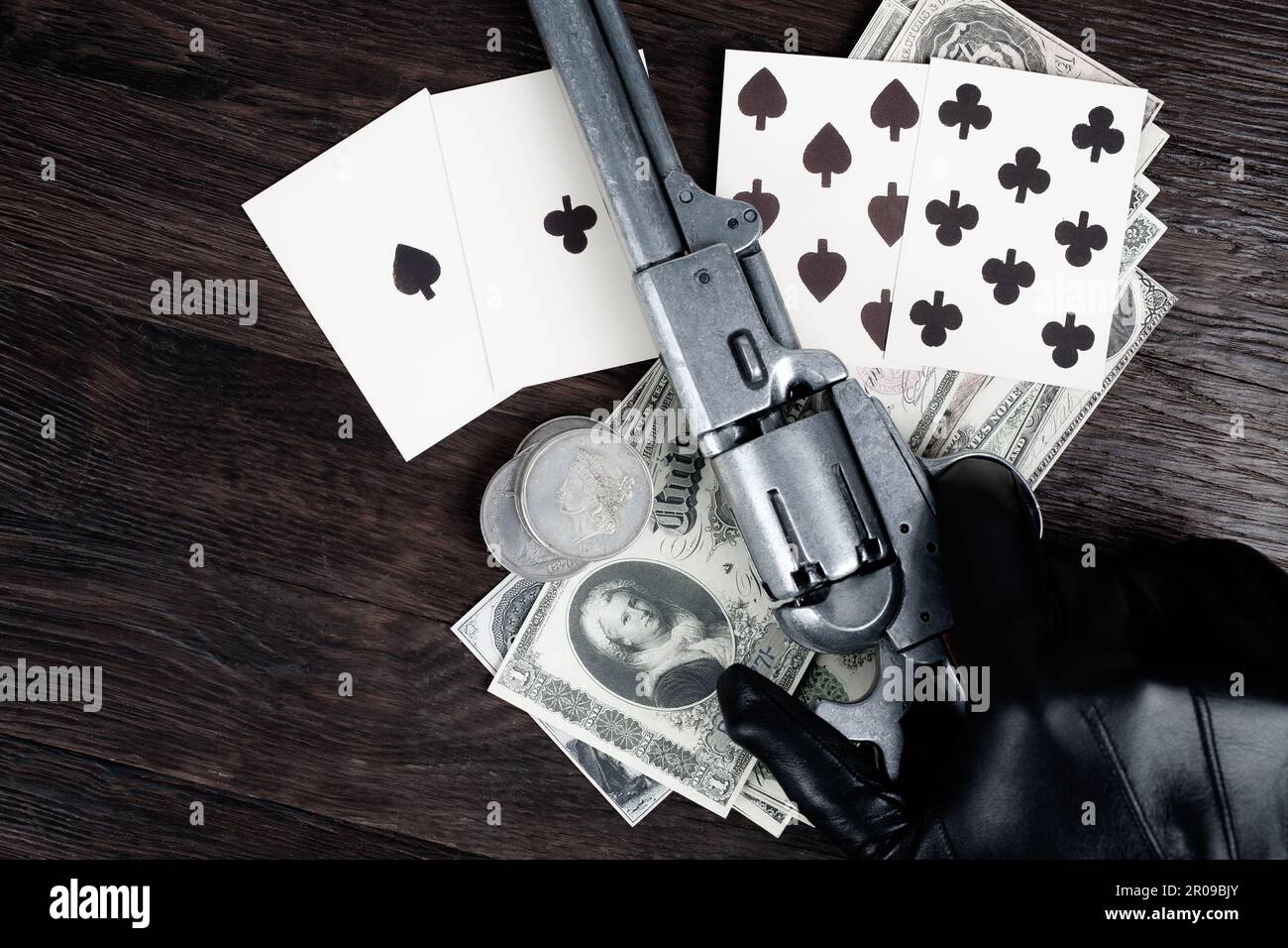 Dead man's hand. Two-pair poker hand consisting of the black aces and black eights and player hand with revolver. Stock Photo