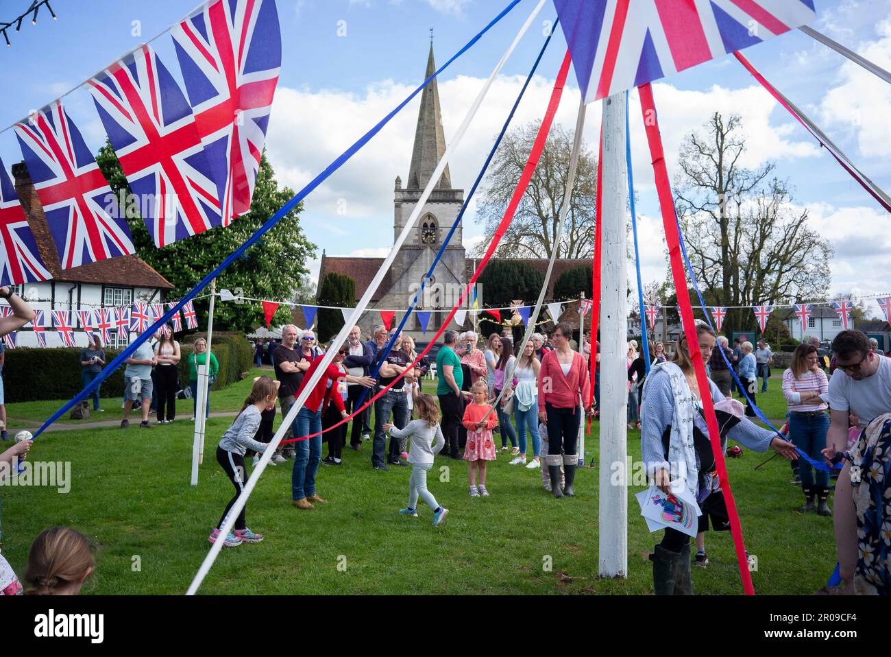 Brockham, Surrey, England, UK. 7th May, 2023. Residents of Brockham village in the county of Surrey held festivities on the village green, along with other community parties taking place throughout the United Kingdom. Children learnt the joys of the ancient tradition of maypole dancing, Mum's were subjected to a ''˜best dressed in toilet roll paper by children' competition outside the village pub, and others enjoyed tea and cake courtesy of the church hall. Street parties and celebrations continued throughout the United Kingdom over a special extended holiday weekend. (Credit Ima Stock Photo
