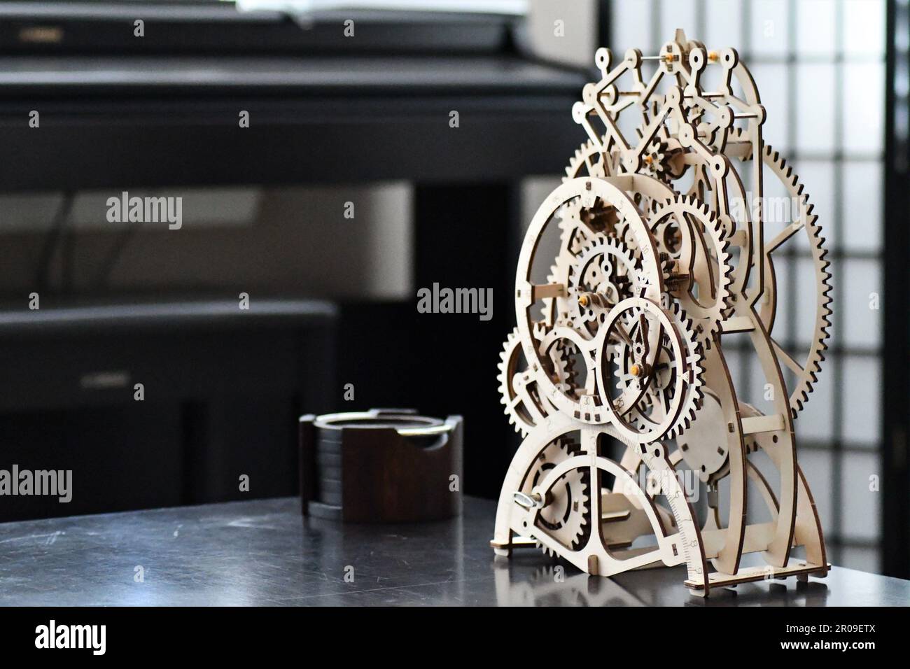 A wooden mechanical clock with exposed gears Stock Photo Alamy