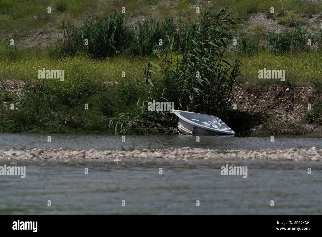 A bath tub dumped by the river. Destruction of the environment. Stock Photo