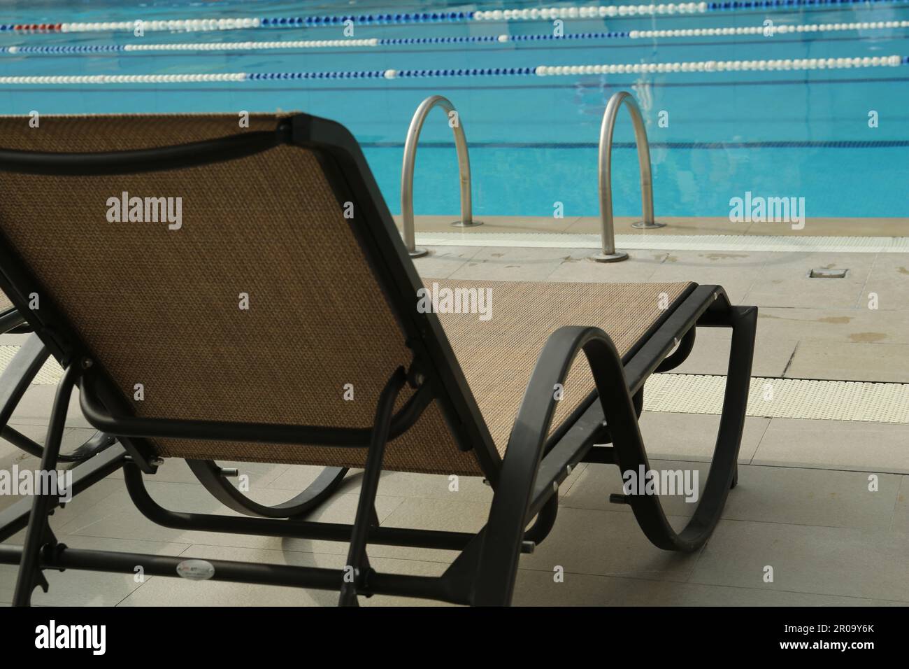Sunbed near swimming pool at luxury resort Stock Photo Alamy