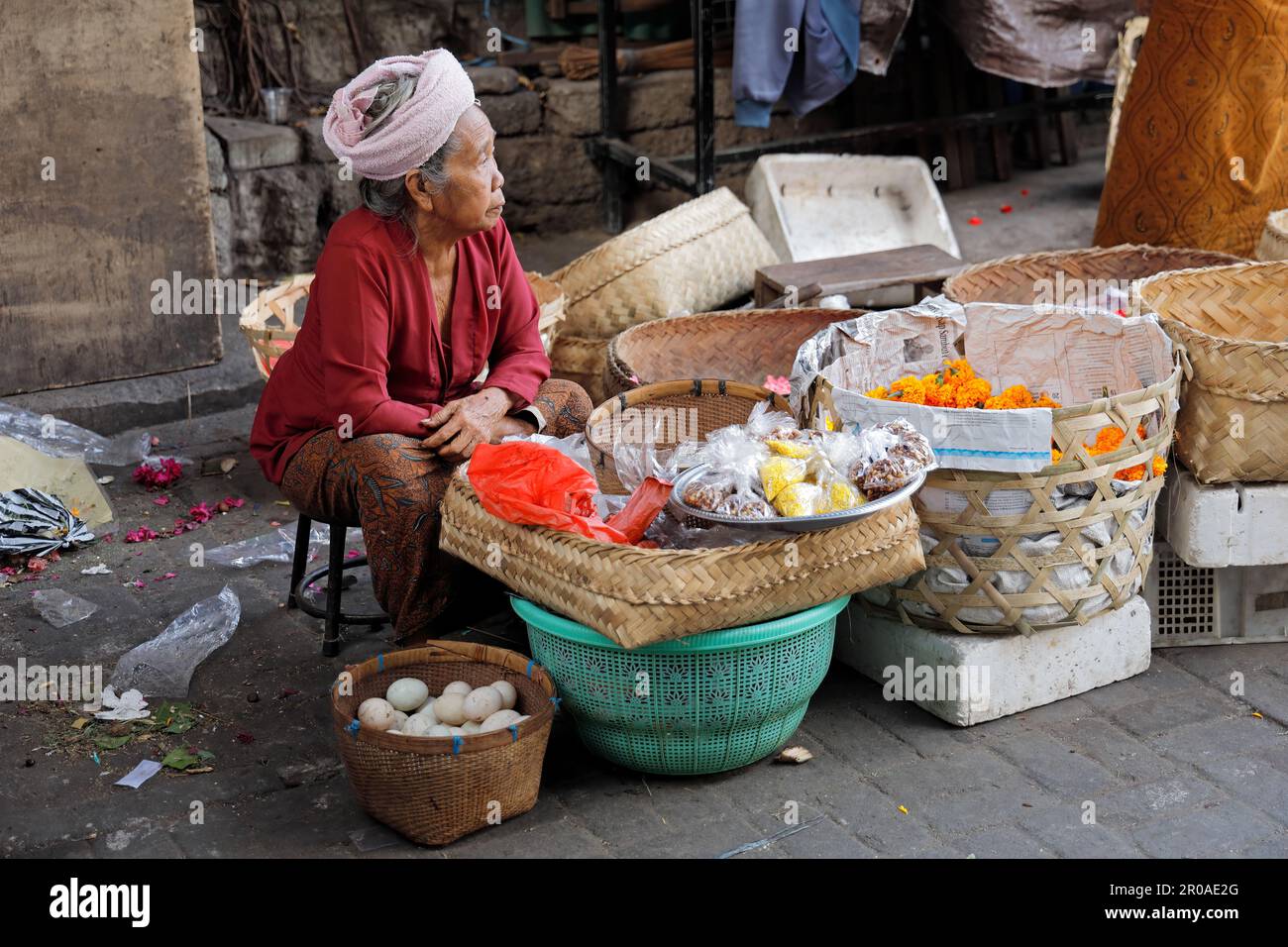 Ubud, Bali, Indonesia - September 5, 2019: Indonesian woman selling produce in a traditional open market on the streets of the popular tourist town Stock Photo