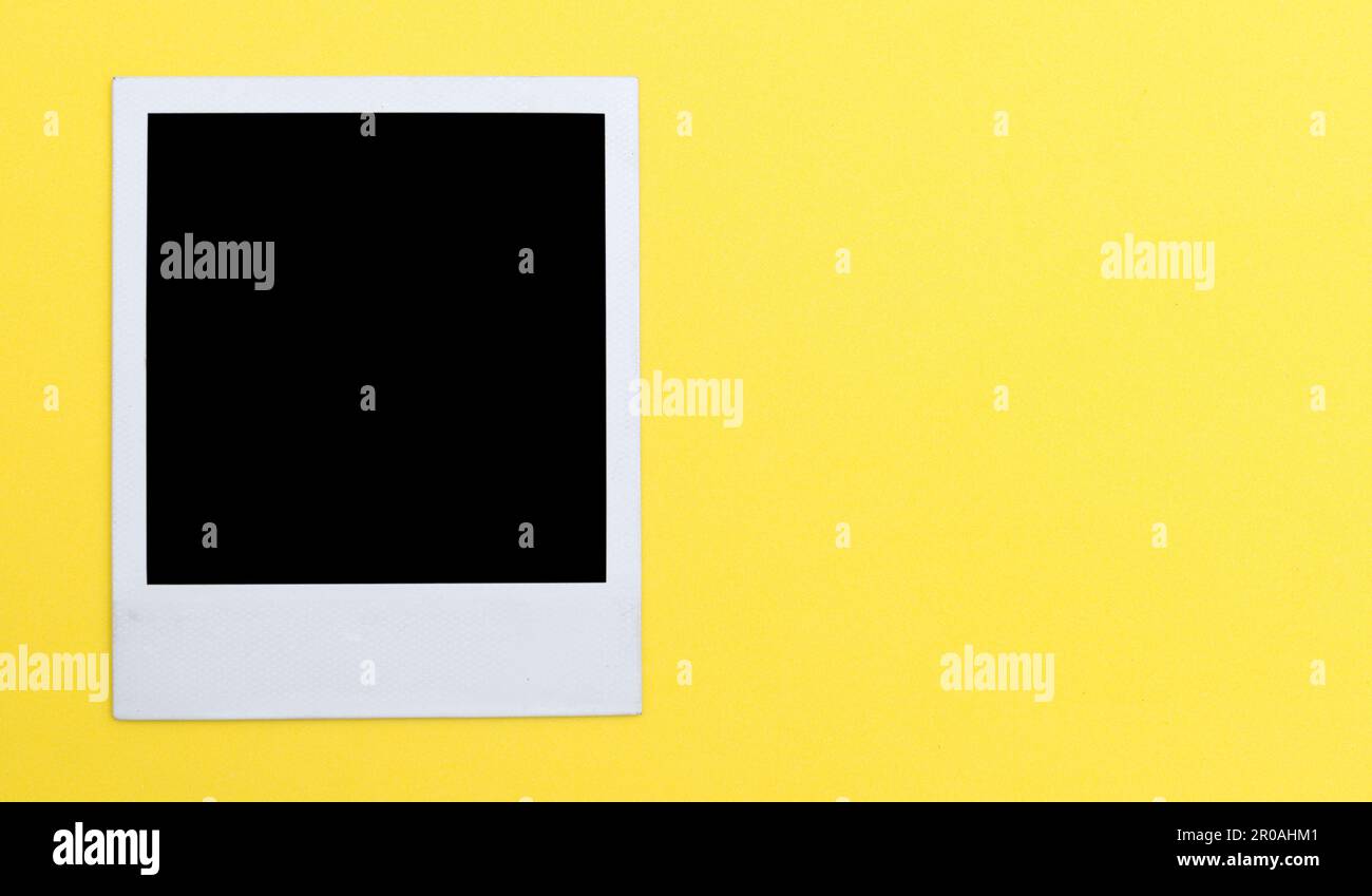 Polaroid photo frame on yellow background Stock Photo