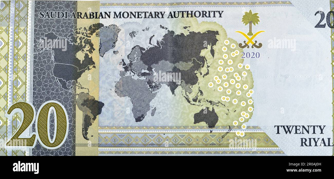 Large fragment of reverse side of 20 SAR twenty Saudi Arabia Riyals banknote currency bill money Commemorative issue with a map of the world depicting Stock Photo