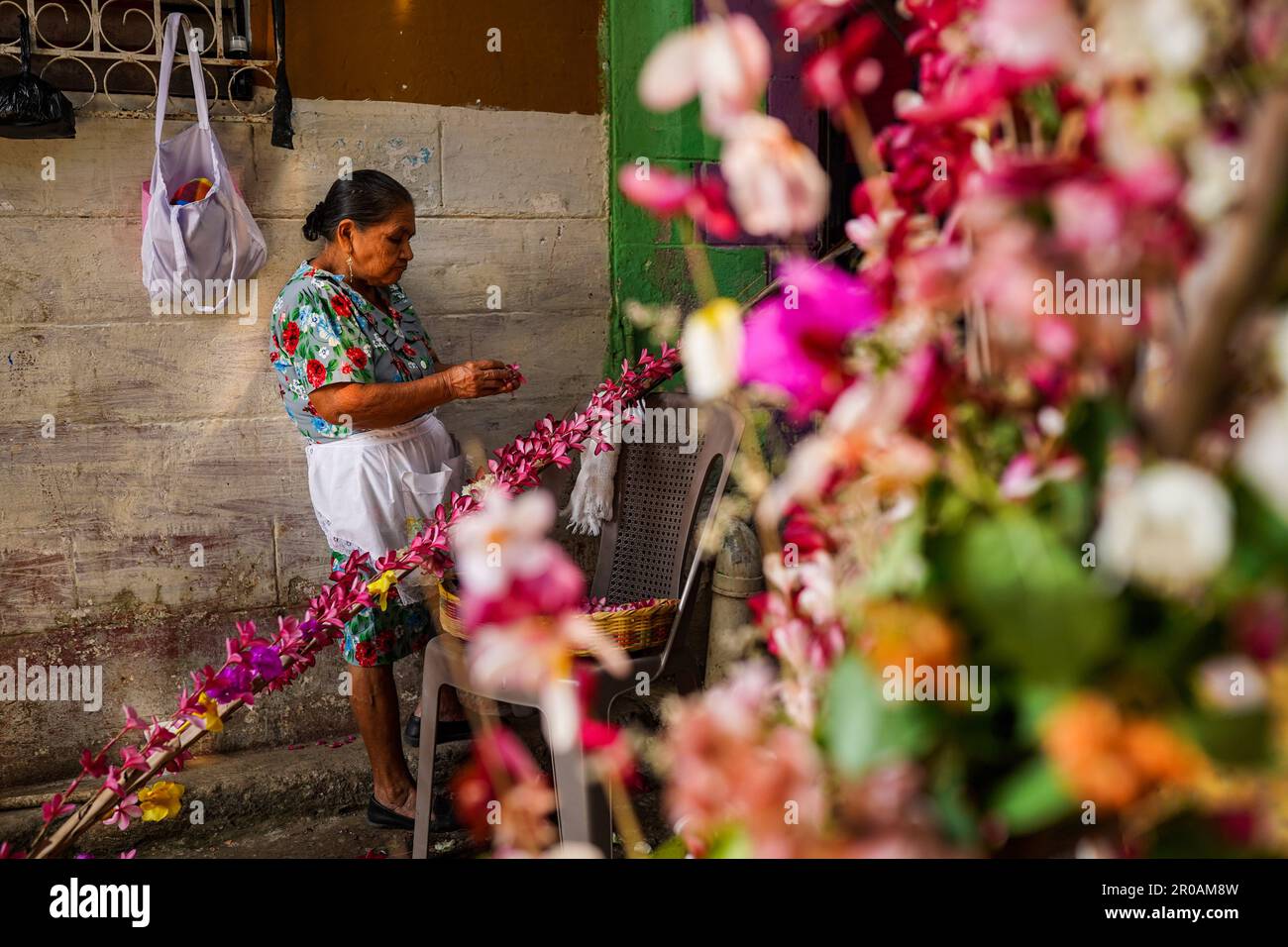 Panchimalco, El Salvador. 07th May, 2023. A faithful weaves flowers into a palm during the XLI flower and palm festival in the indigenous town of Panchimalco. Every May members of the catholic brotherhoods celebrate the flower and palm festival in honor of the Virgin Mary by collecting May Flowers (Plumeria acutifolia) and weaving them into palms. (Photo by Camilo Freedman/SOPA Images/Sipa USA) Credit: Sipa USA/Alamy Live News Stock Photo
