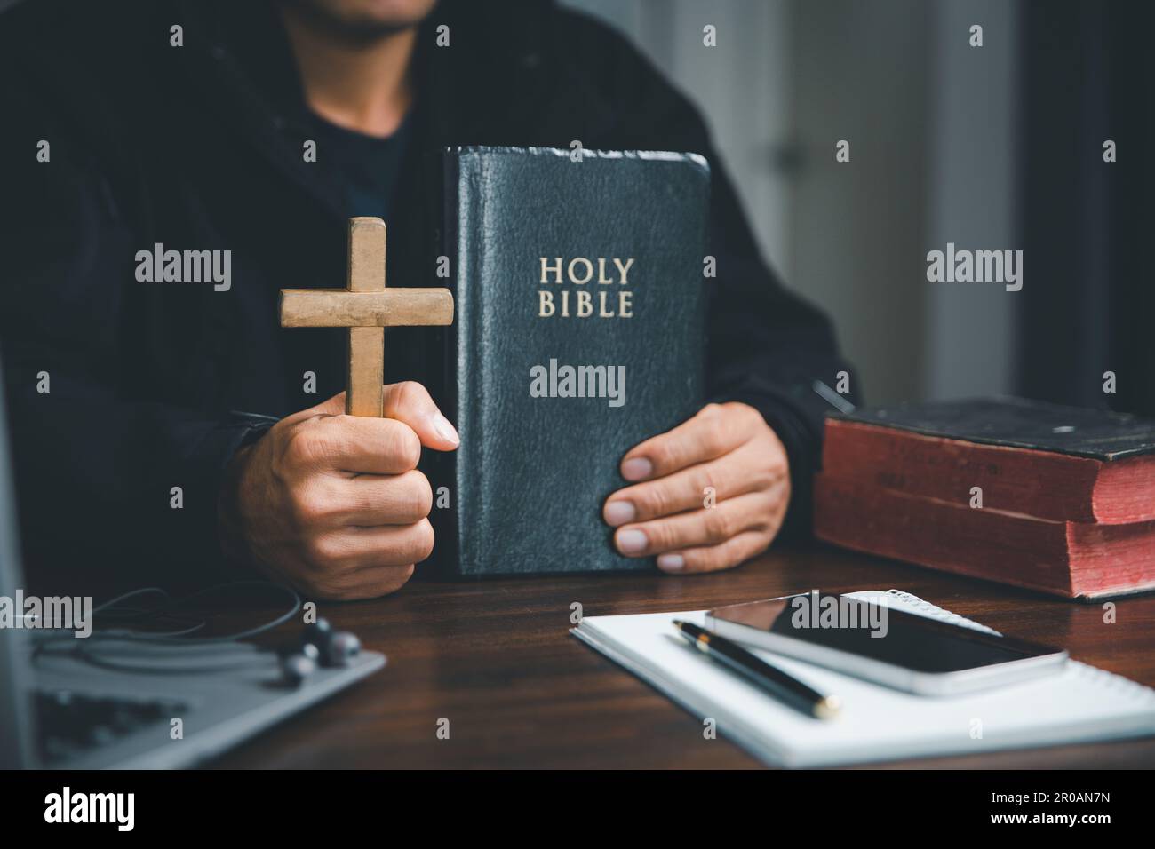 Christian online technology concept. Hands praying of christian with digital computer laptop, Online live church for sunday service. Asian catholic ma Stock Photo