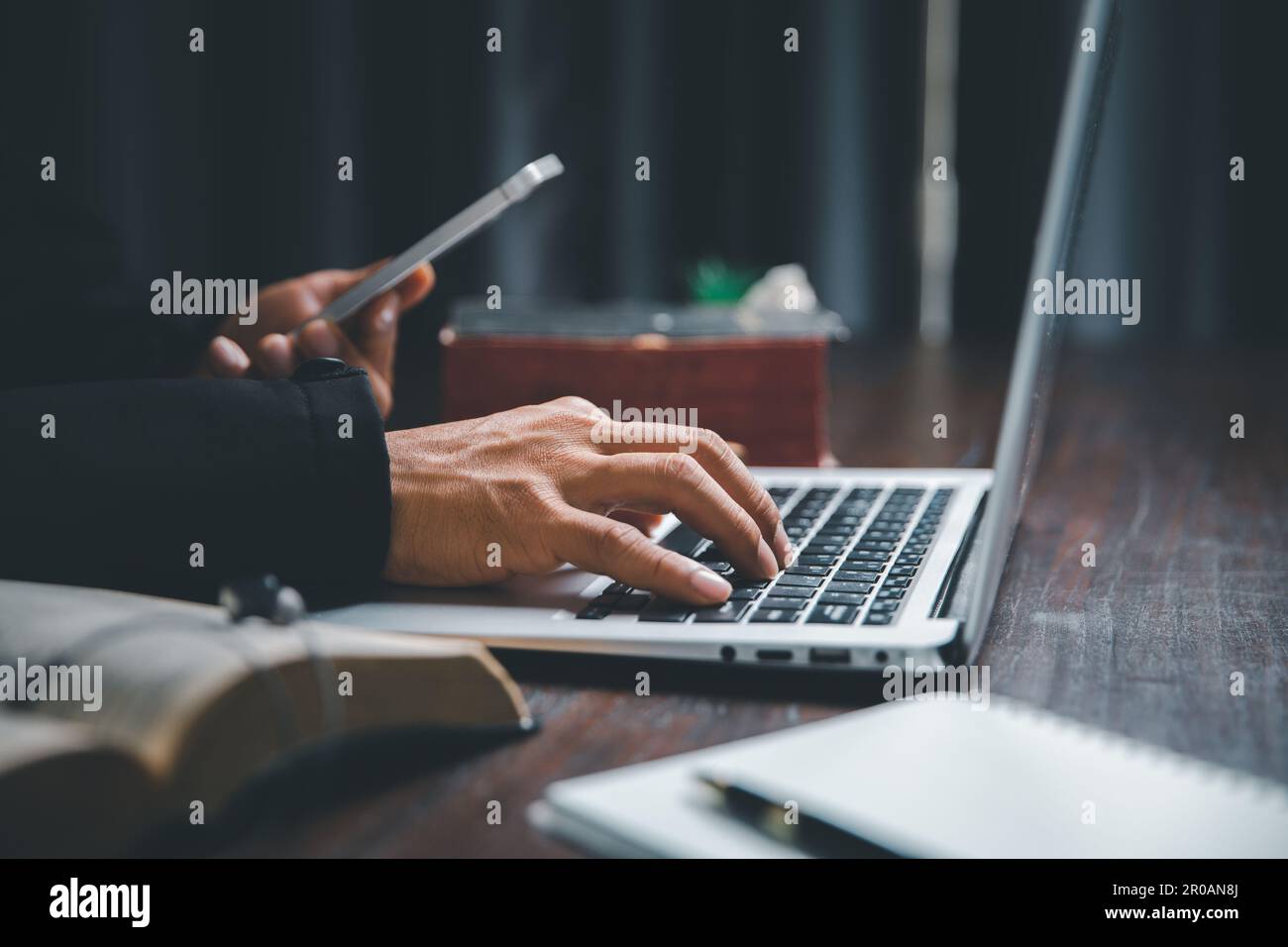 Christian online technology concept. Hands praying of christian with digital computer laptop, Online live church for sunday service. Asian catholic ma Stock Photo