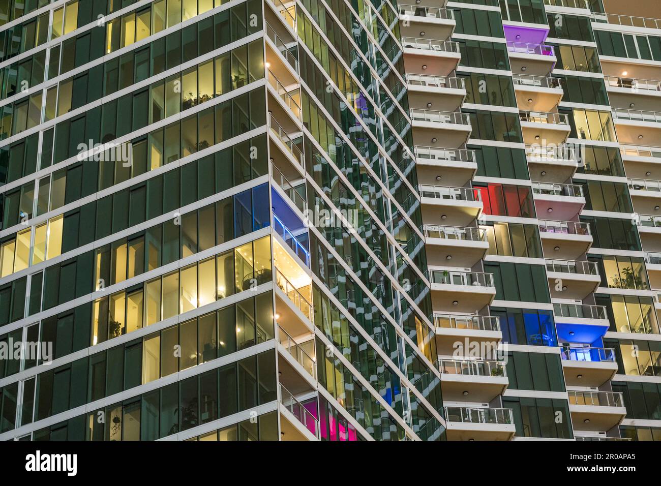 Facade of a high-rise apartment building at night Stock Photo