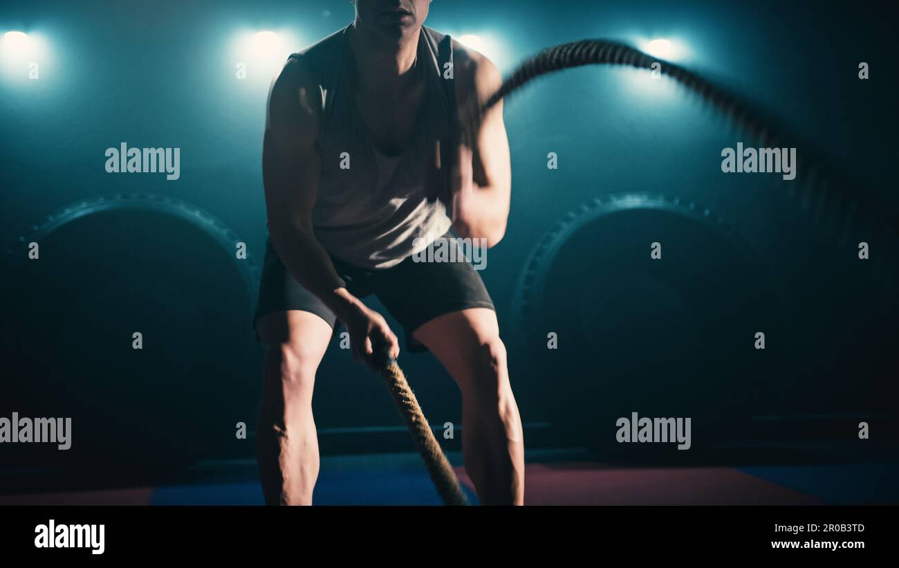Athlete training using battle ropes Stock Photo - Alamy
