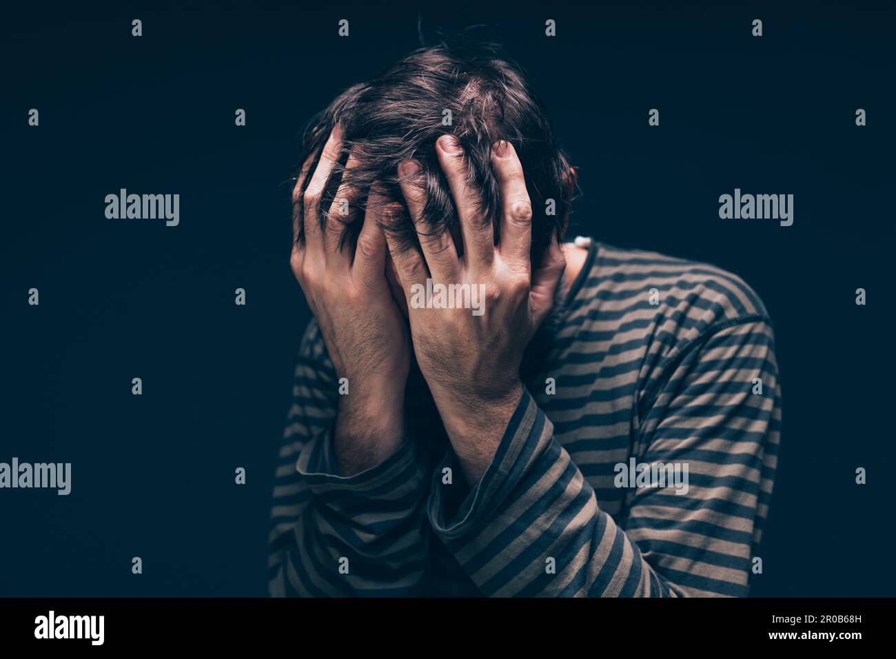 Despair and hopelessness, low key male portrait with selective focus Stock Photo