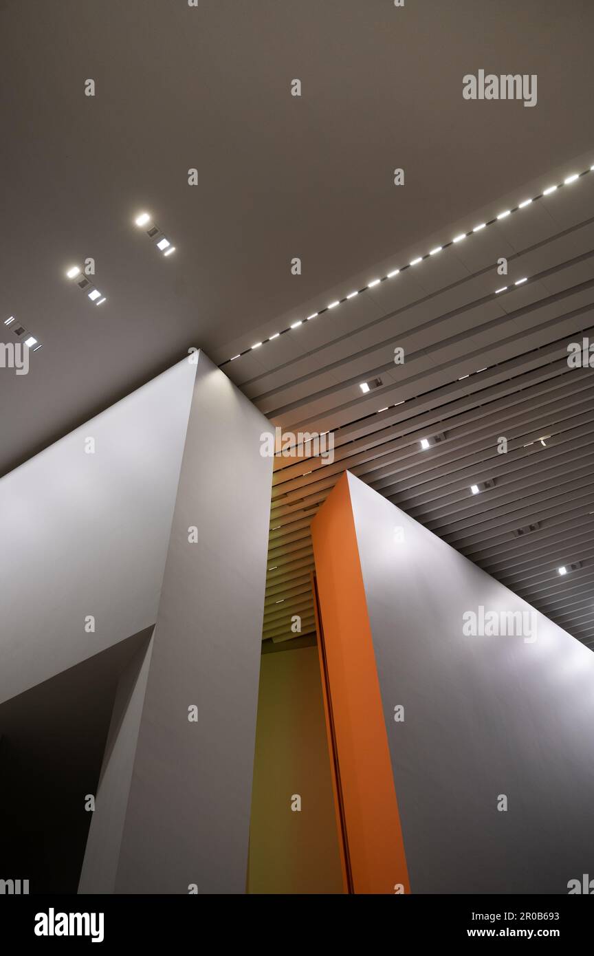 A modern interior of a building featuring a white ceiling with recessed ...