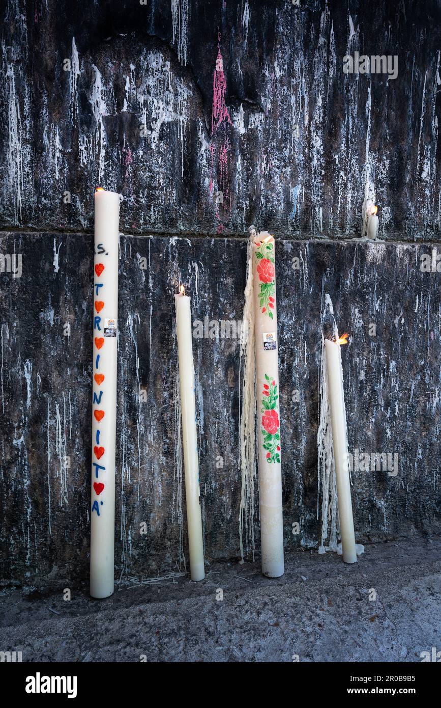 Religious candles lit for devotion by pilgrims who arrive to honor the Holy Trinity of Vallepietra. Vallepietra, Rome province, Lazio, Italy, Europe Stock Photo