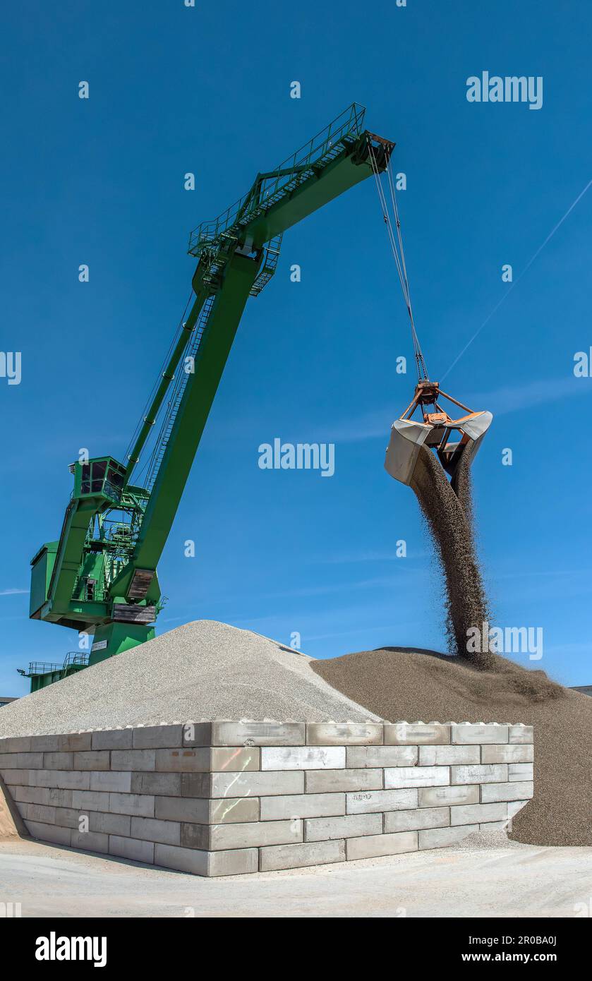 Exterior view of a cement factory with green crane Stock Photo