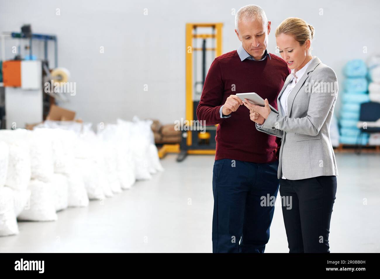 Making notes during an inspection. managers inside of a warehouse Stock ...