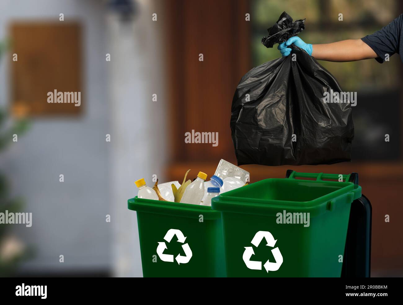 person hand holding garbage bag bag in to trash dump food environment ...