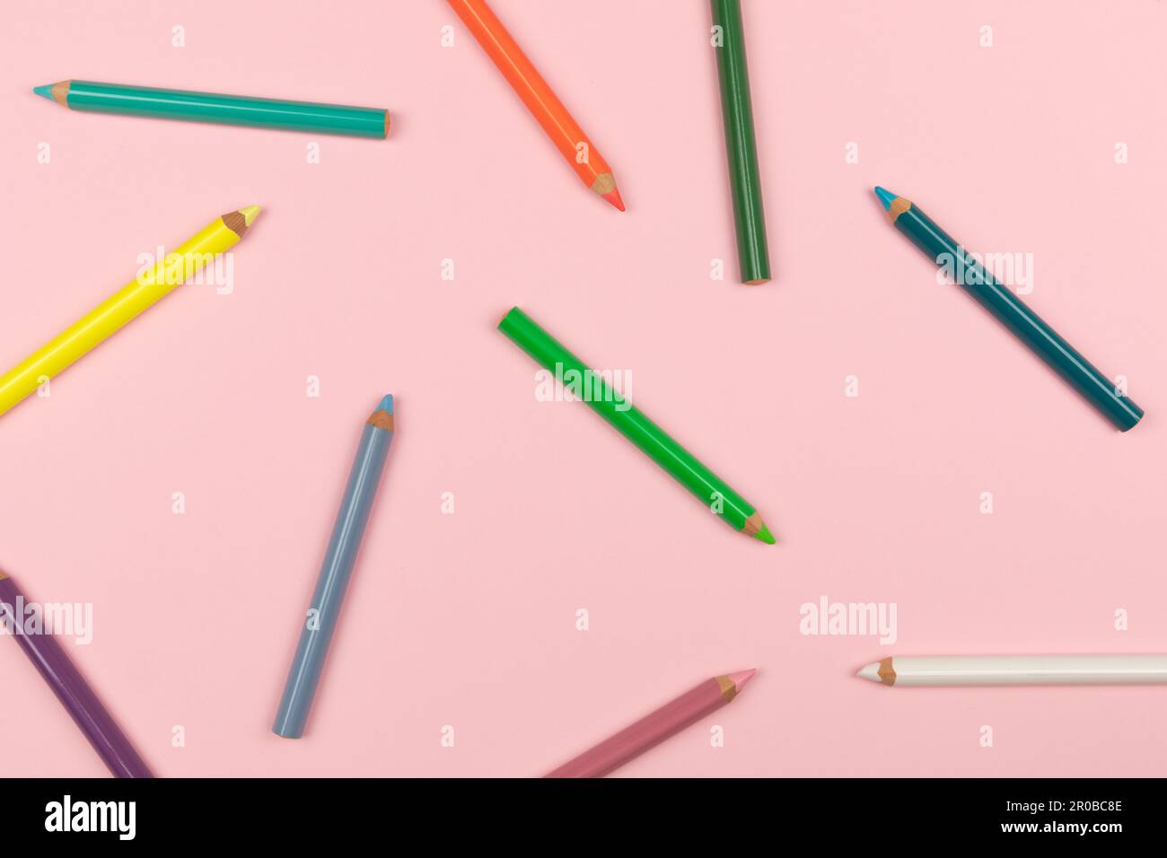 Colored pencils on the pink background. Top view Stock Photo - Alamy