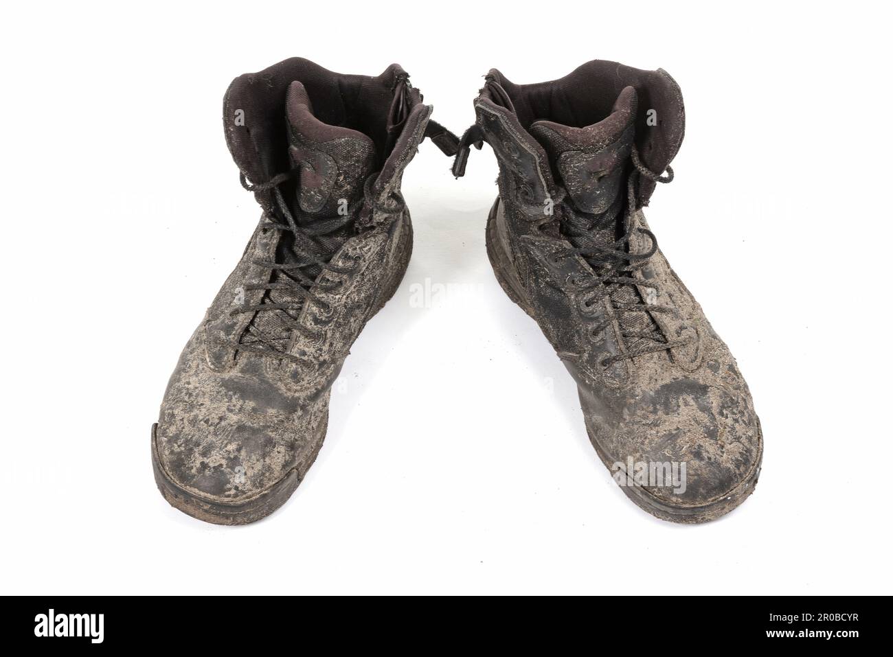 Black shoes, covered in mud, isolated on white Stock Photo - Alamy