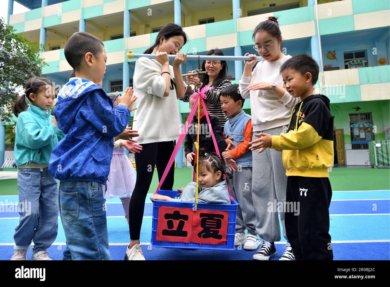 Children experience the custom of getting weighed and paint eggs to ...